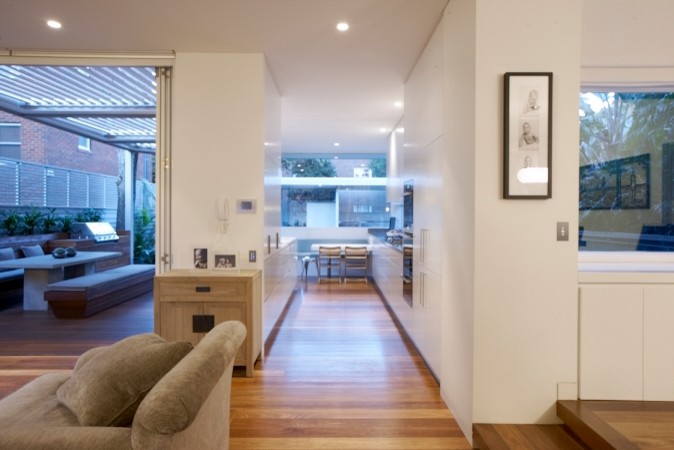 Design ideas for a large classic open plan living room in Sydney with white walls and light hardwood flooring.