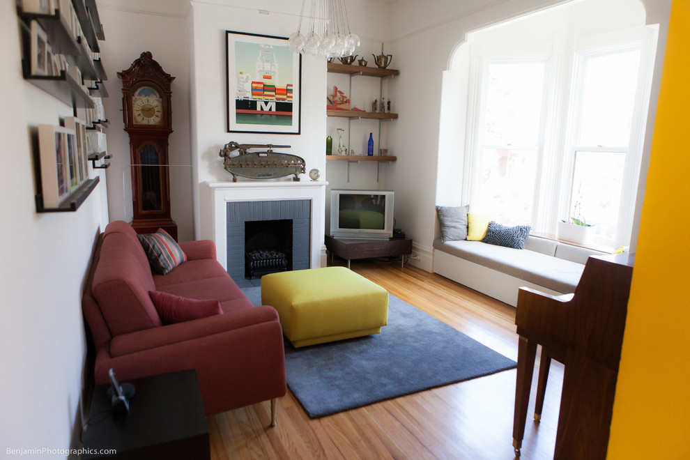 Mittelgroßes, Abgetrenntes Modernes Wohnzimmer mit weißer Wandfarbe, hellem Holzboden, Kamin, Kaminumrandung aus Backstein und Eck-TV in San Francisco