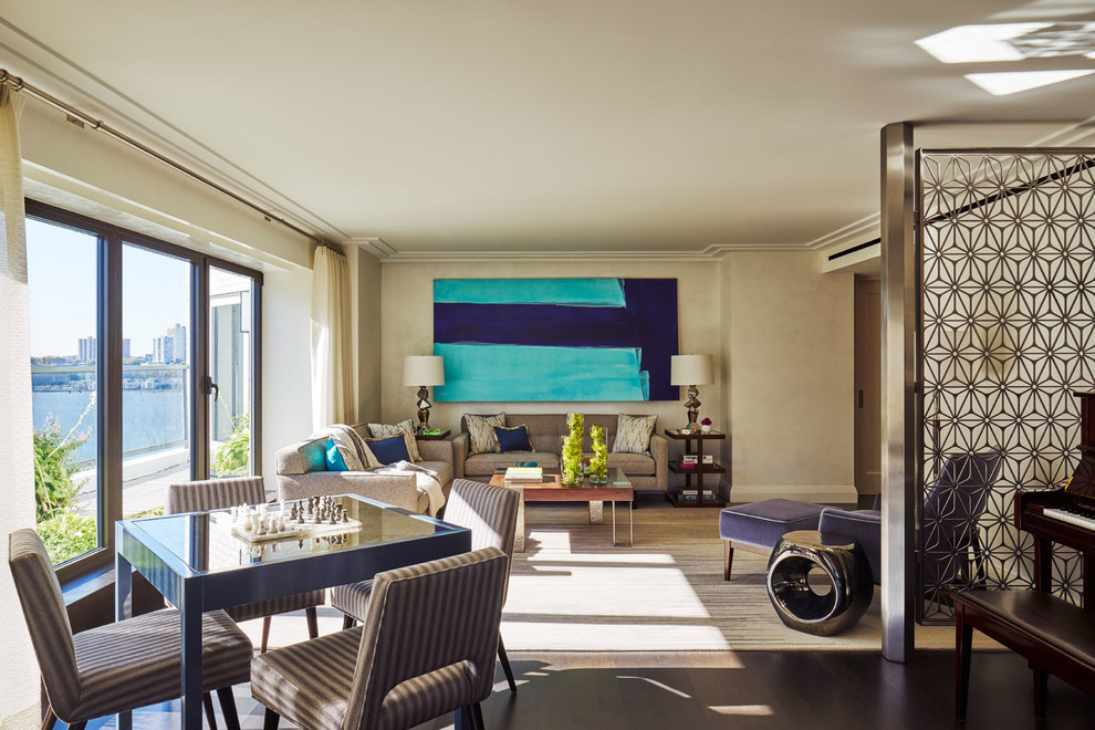 Example of a trendy open concept dark wood floor and brown floor living room design in New York with beige walls