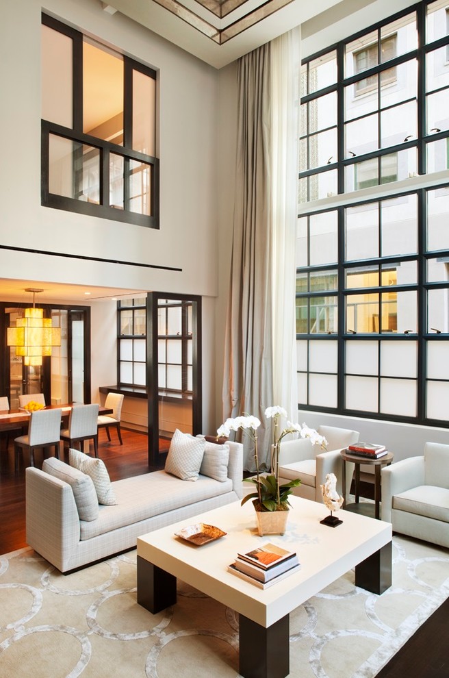 Ejemplo de salón para visitas abierto actual con paredes blancas y suelo de madera en tonos medios
