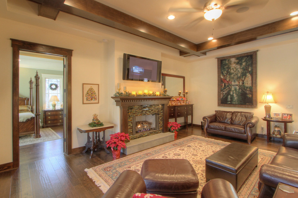 Arts and crafts open concept dark wood floor living room photo in Atlanta with a standard fireplace, a tile fireplace and a wall-mounted tv