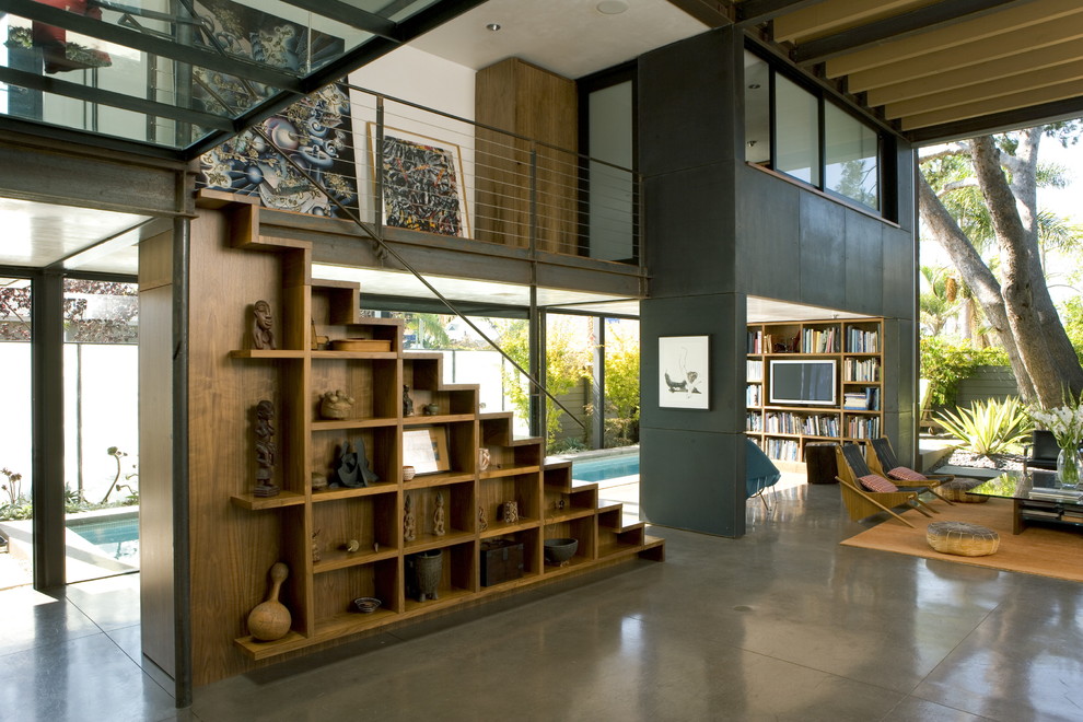 Example of a large urban open concept concrete floor and gray floor living room design in Los Angeles with black walls