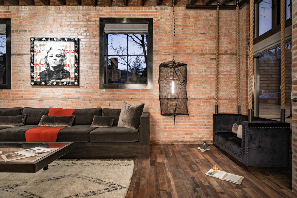 Design ideas for an industrial open plan living room in Denver with red walls and dark hardwood flooring.