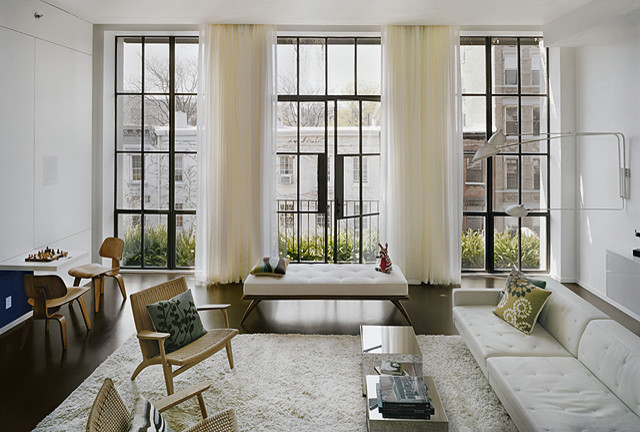 Example of a large minimalist concrete floor living room design in New York with white walls