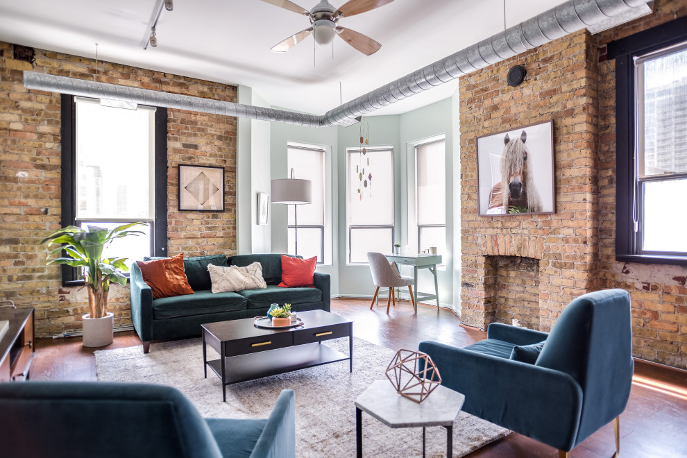 Inspiration for an urban grey and teal living room in Chicago with grey walls, dark hardwood flooring and brown floors.