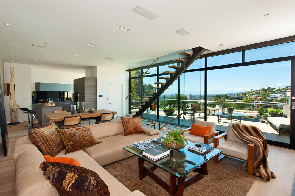 Example of a trendy formal and open concept light wood floor living room design in Los Angeles with white walls