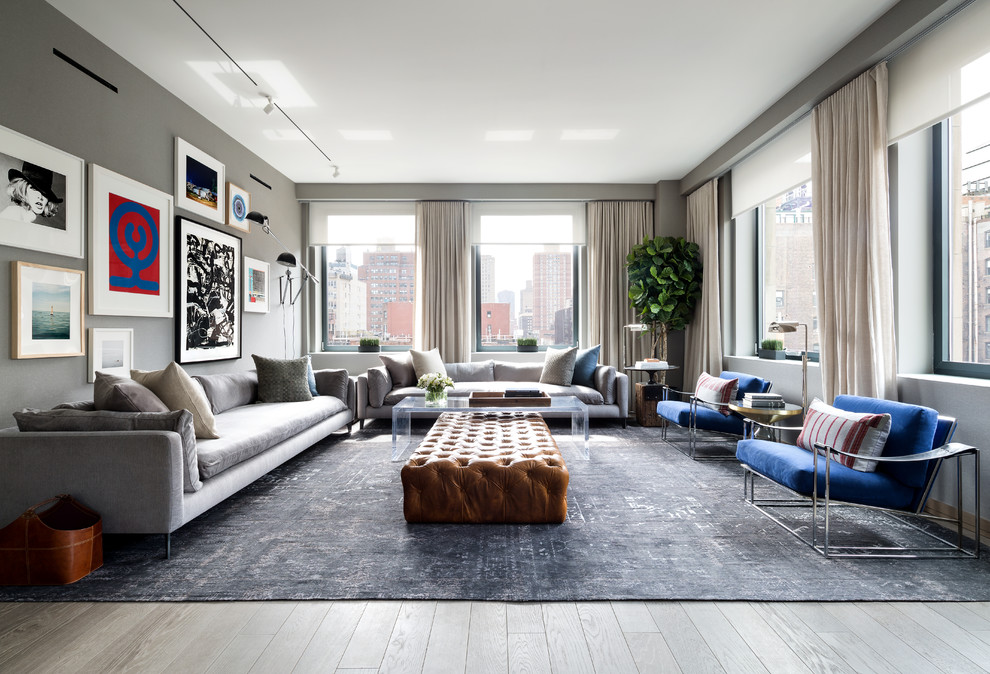 Example of a trendy formal light wood floor living room design in New York with gray walls