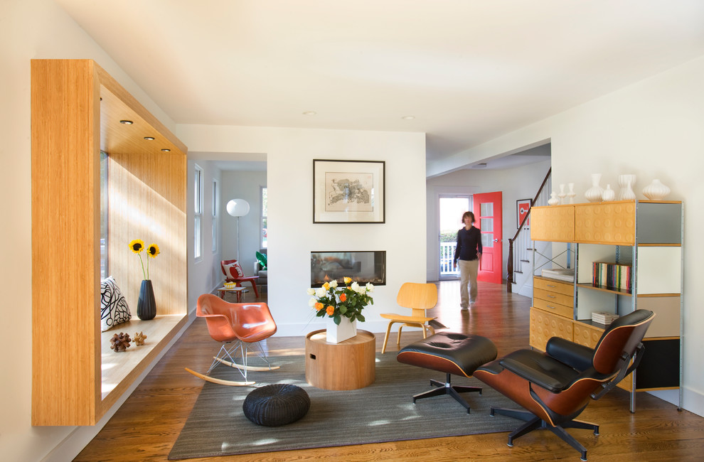 Example of a large trendy formal and open concept dark wood floor living room design in Boston with a two-sided fireplace, white walls, a plaster fireplace and no tv