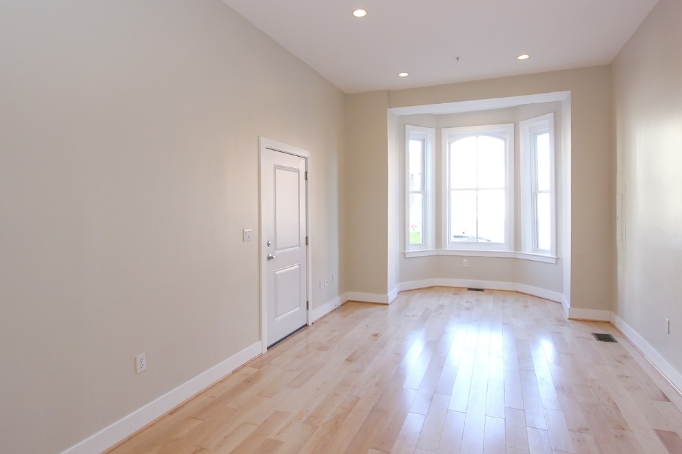 Immagine di un piccolo soggiorno minimalista chiuso con pareti beige, parquet chiaro, nessun camino e nessuna TV