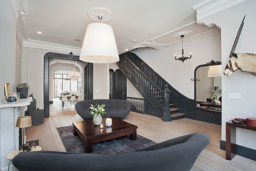 Living room - scandinavian formal and open concept light wood floor living room idea in New York with gray walls and a standard fireplace