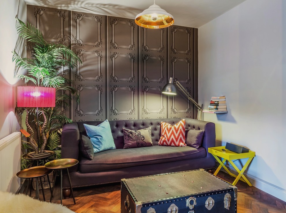 Eclectic formal enclosed living room feature wall in Edinburgh with white walls and medium hardwood flooring.