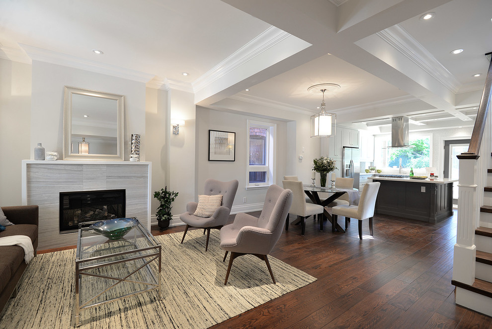 Inspiration for a mid-sized transitional open concept dark wood floor and brown floor living room remodel in Toronto with gray walls, a standard fireplace and a tile fireplace