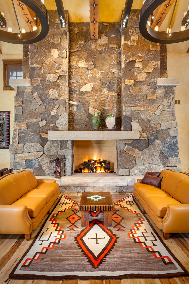 Réalisation d'un salon sud-ouest américain avec une salle de réception, parquet clair, une cheminée standard et un manteau de cheminée en pierre.
