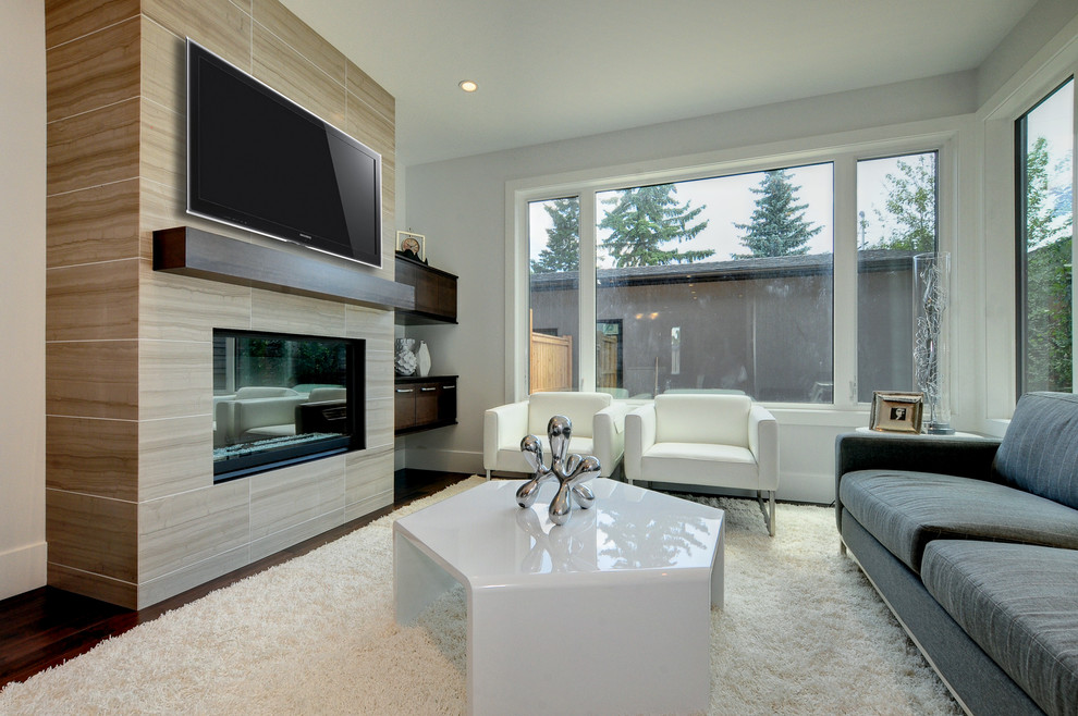 Design ideas for a contemporary living room in Calgary with a tiled fireplace surround.