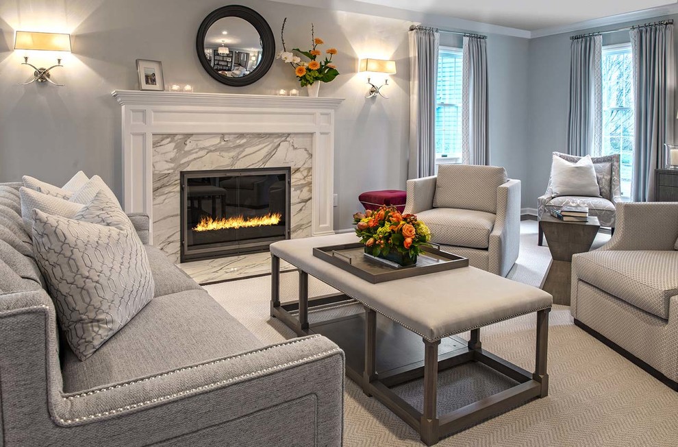 A large fireplace with white mantle and marble surround. Transitional Living Room New York