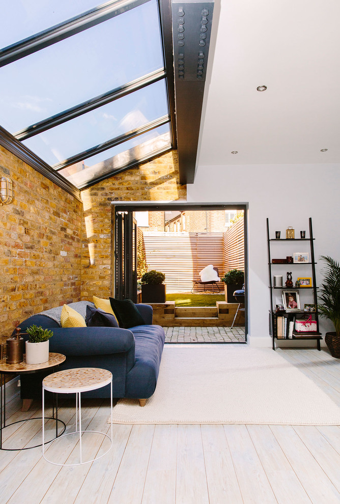 Large urban formal and open concept vinyl floor and white floor living room photo in London with white walls, a standard fireplace and a wall-mounted tv
