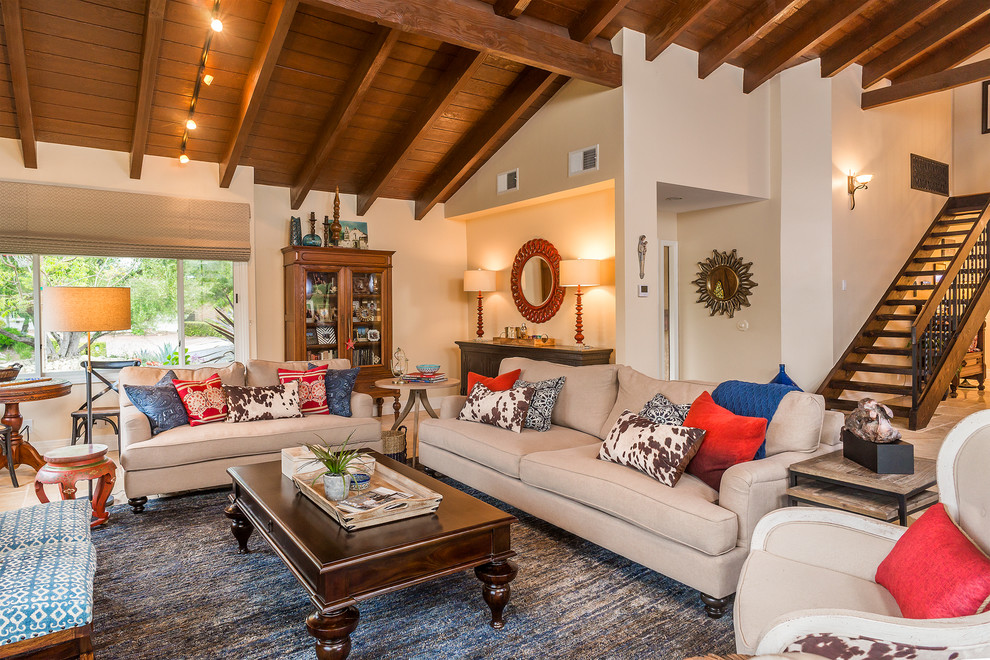 Example of a mid-sized mountain style open concept travertine floor living room design in Los Angeles with beige walls, a standard fireplace and a stone fireplace