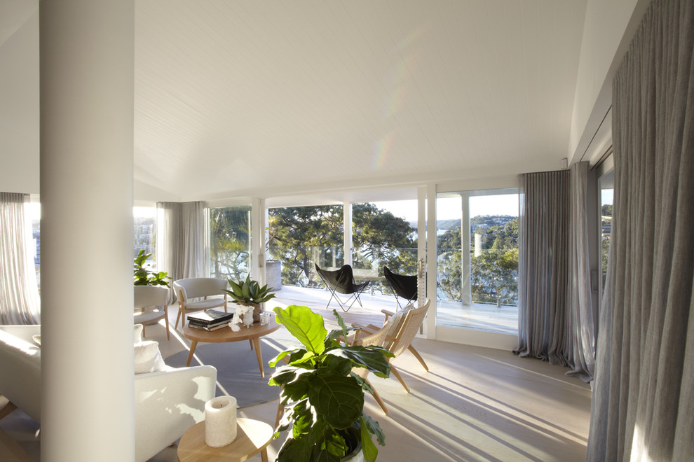 Contemporary living room in Sydney with light hardwood flooring.