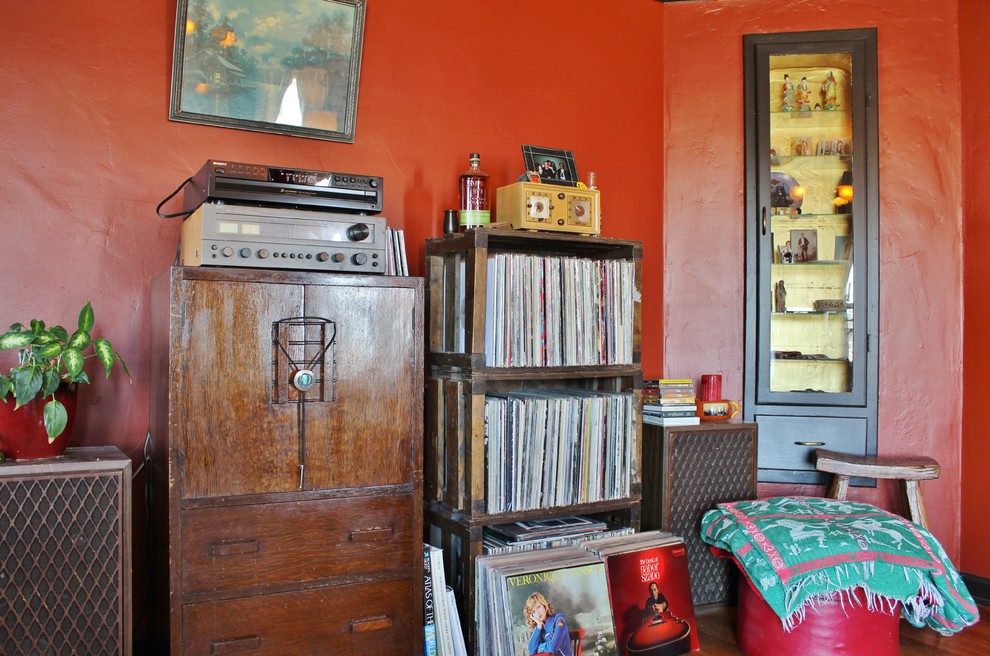 Example of an eclectic enclosed living room design in Seattle with red walls, a standard fireplace and a tile fireplace