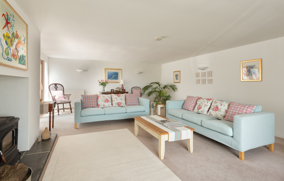 Living room - large coastal formal and enclosed living room idea in Devon with white walls and a wood stove