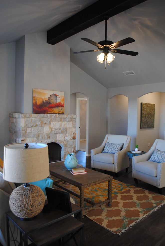 Mid-sized eclectic formal and open concept vinyl floor living room photo in Austin with gray walls, a standard fireplace, a stone fireplace and a wall-mounted tv