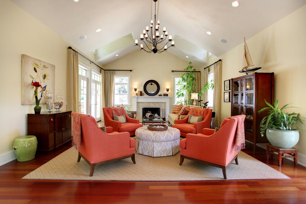 Example of a large classic living room design in Los Angeles with beige walls and a standard fireplace