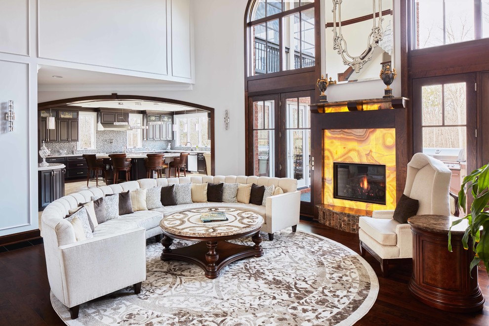 Inspiration for a medium sized traditional enclosed living room in Raleigh with white walls, dark hardwood flooring, a standard fireplace, a stone fireplace surround and brown floors.