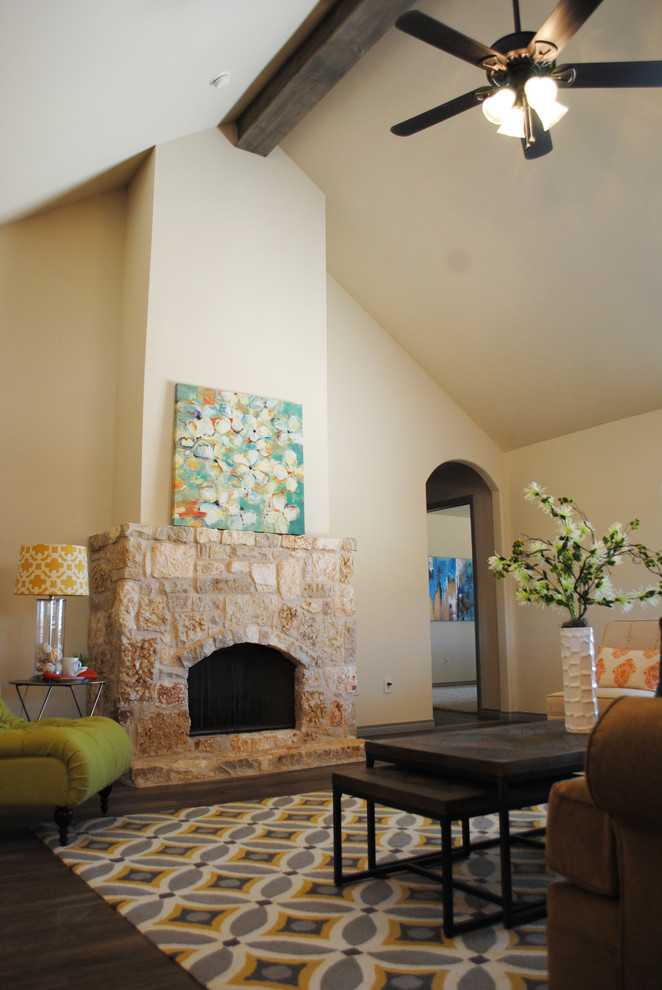 Inspiration for a large eclectic open plan living room in Austin with beige walls, vinyl flooring, a standard fireplace, a stone fireplace surround and a wall mounted tv.
