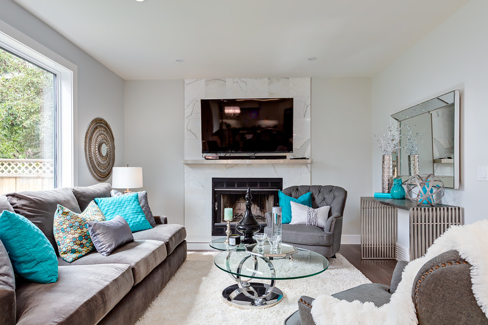 Inspiration for a medium sized traditional grey and teal open plan living room in Calgary with blue walls, medium hardwood flooring, a standard fireplace, a stone fireplace surround and a wall mounted tv.