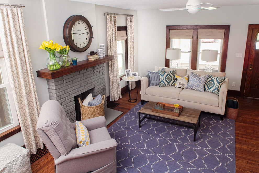 Traditional living room in San Francisco with white walls, dark hardwood flooring, a standard fireplace and a brick fireplace surround.