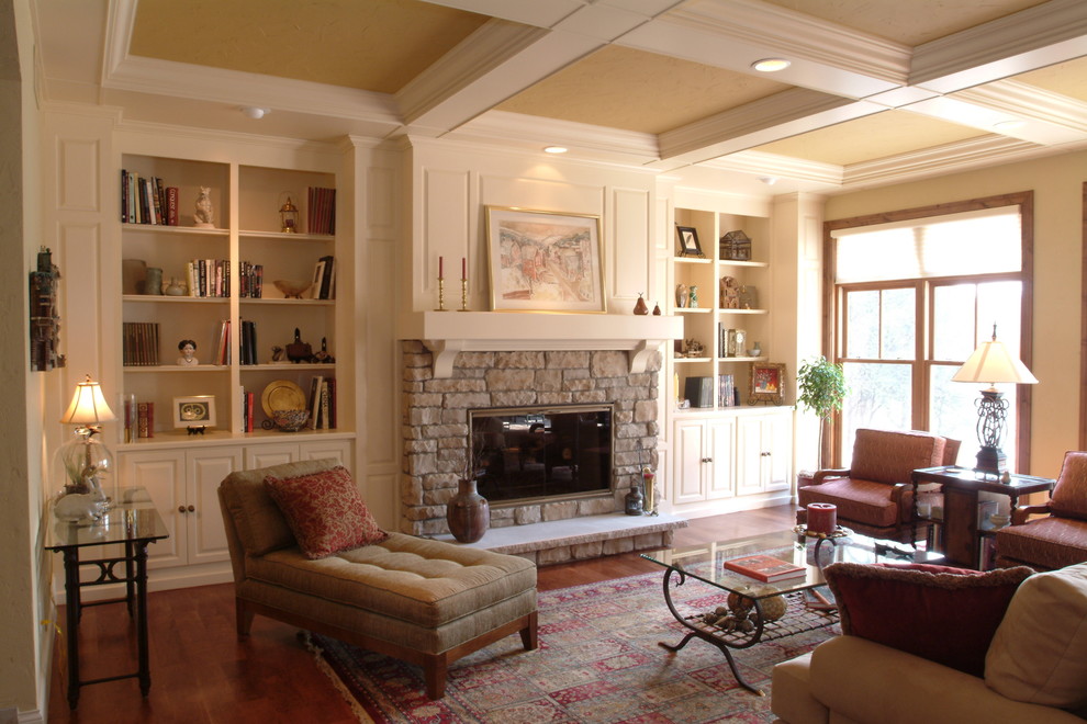 Living room - mid-sized traditional formal and open concept medium tone wood floor and brown floor living room idea in Milwaukee with beige walls, a standard fireplace, a stone fireplace and no tv