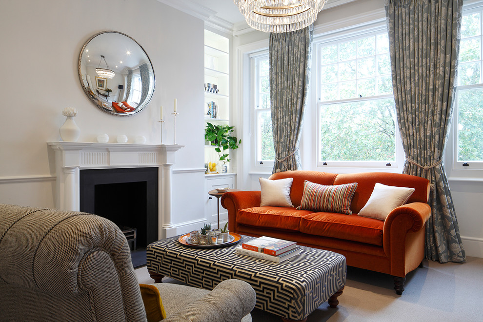 Inspiration for a classic formal enclosed living room in London with beige walls, carpet, a standard fireplace, a metal fireplace surround and beige floors.
