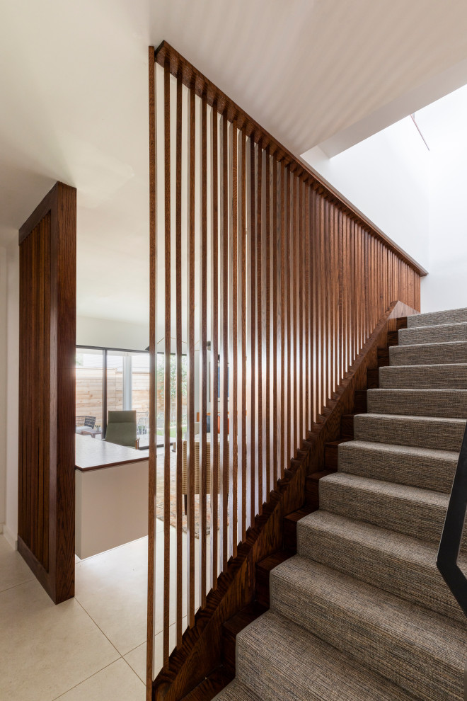 Photo of a medium sized contemporary staircase in Houston with wood walls.