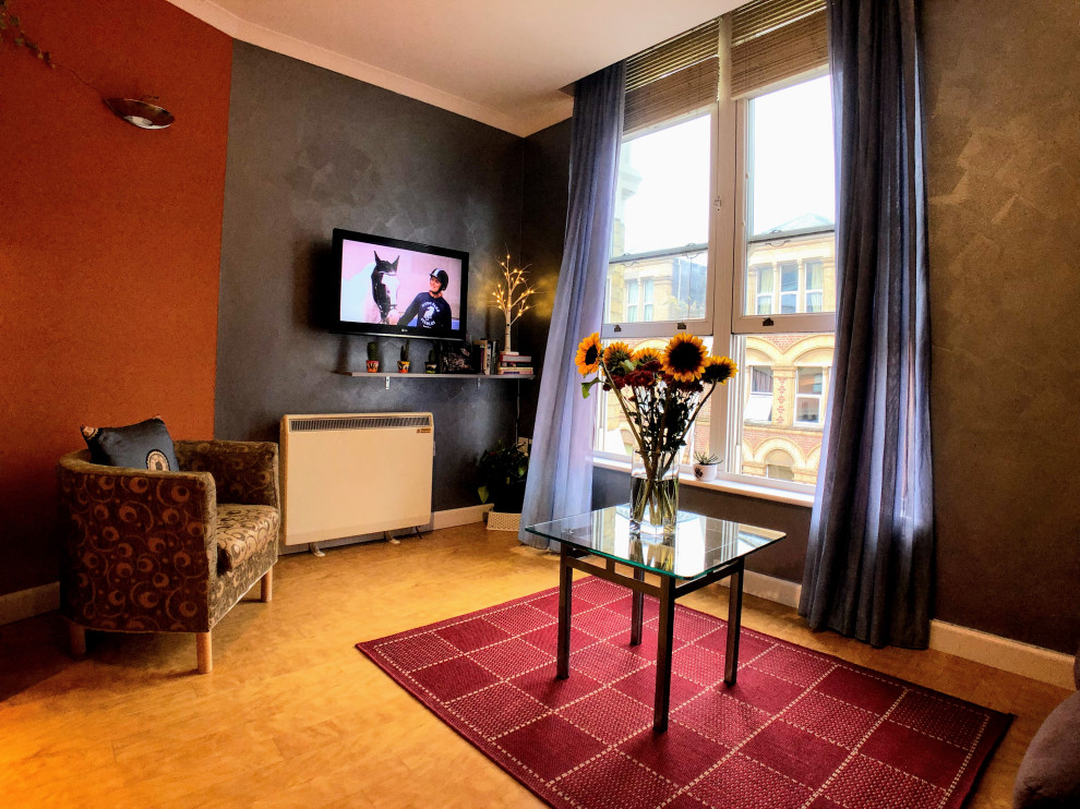 Ispirazione per un piccolo soggiorno classico chiuso con sala formale, pareti multicolore, pavimento in vinile, TV a parete e pavimento arancione