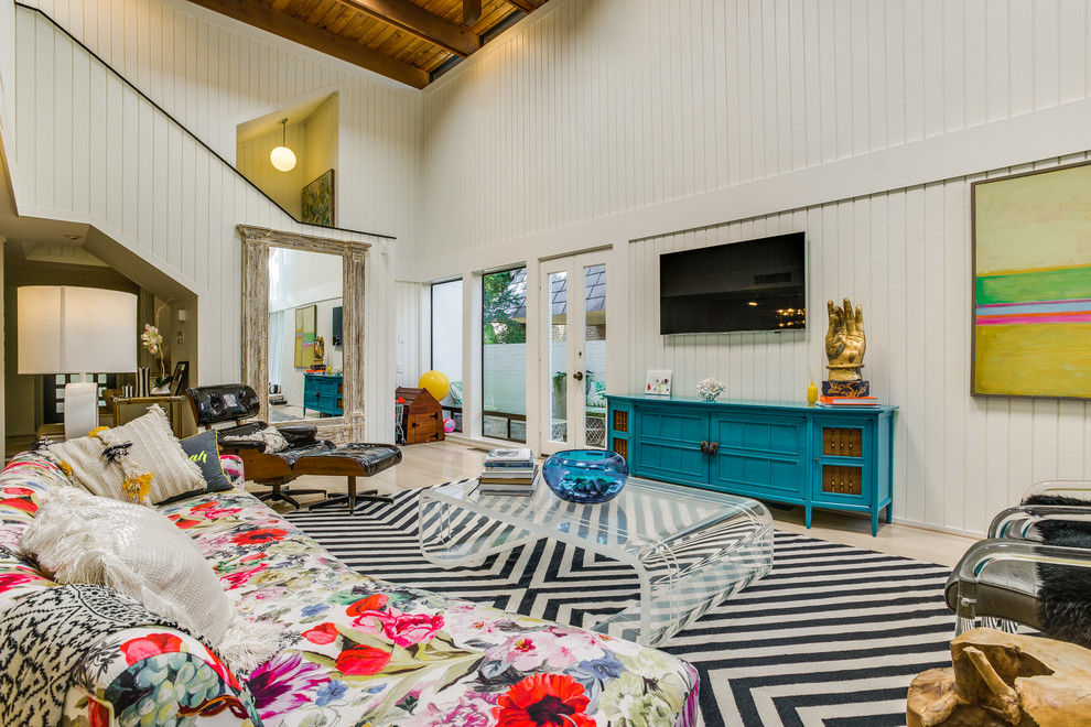 Inspiration for a large eclectic open concept light wood floor living room remodel in Dallas with white walls and a wall-mounted tv
