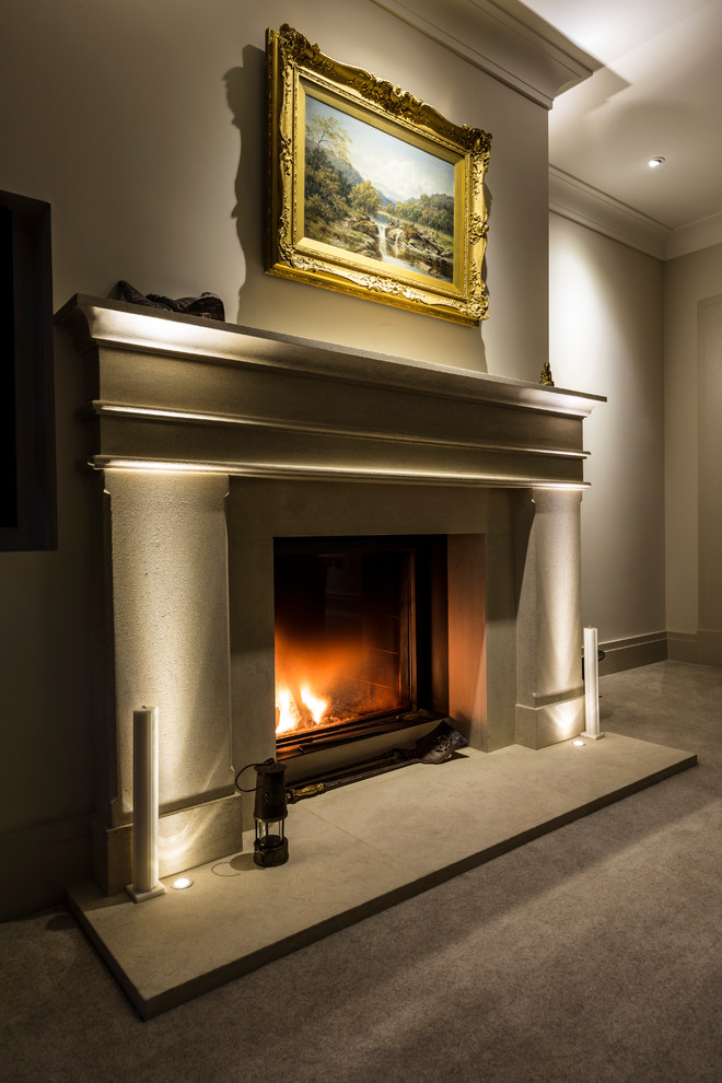 Inspiration for a medium sized traditional enclosed living room in Surrey with white walls, carpet, a two-sided fireplace, a stone fireplace surround and a wall mounted tv.
