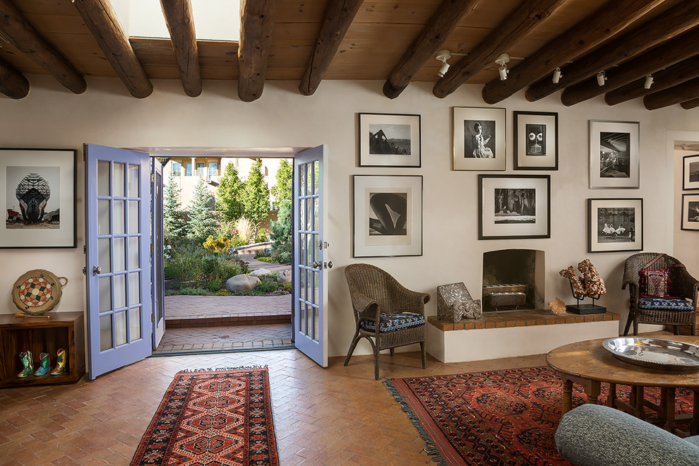 Repräsentatives, Fernseherloses, Offenes Mediterranes Wohnzimmer mit weißer Wandfarbe, Kamin und braunem Boden in Albuquerque