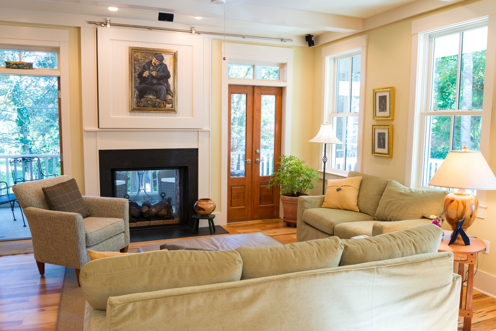 Example of a country living room design in Other with a two-sided fireplace