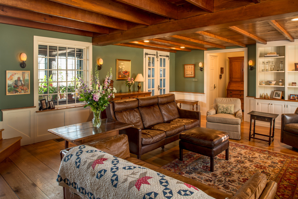 Elegant enclosed medium tone wood floor living room photo in Philadelphia with green walls
