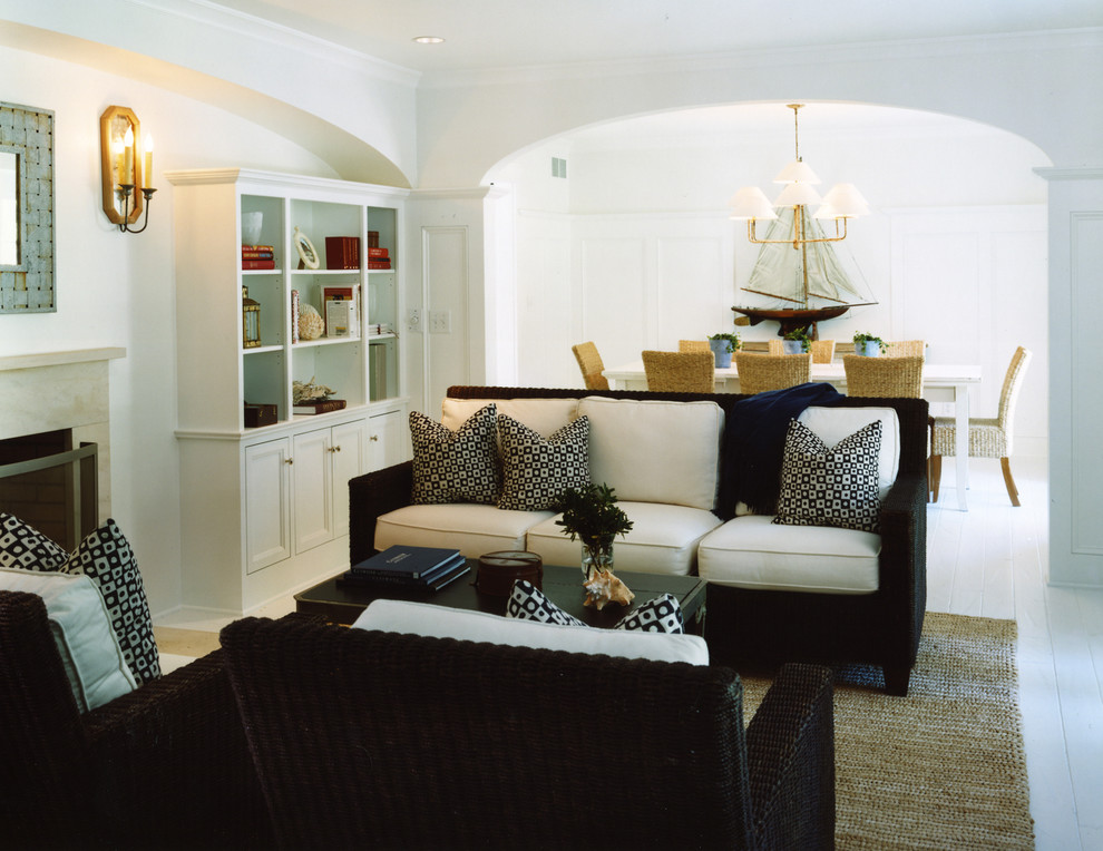 Nautical living room in DC Metro with white walls, painted wood flooring, a standard fireplace and a stone fireplace surround.