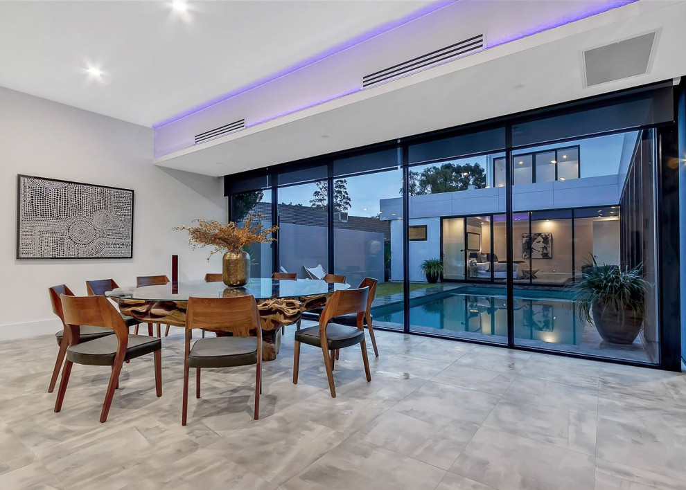 Example of a large trendy open concept ceramic tile, gray floor and coffered ceiling living room design in Adelaide with white walls and a media wall