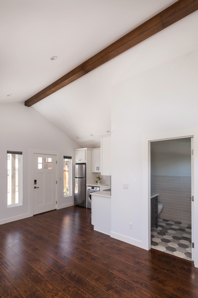 Example of a small transitional open concept laminate floor and brown floor living room design in Los Angeles with white walls