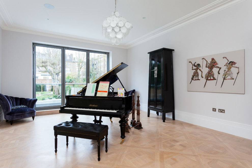 Large transitional light wood floor living room photo in London with a music area, white walls, no fireplace and no tv