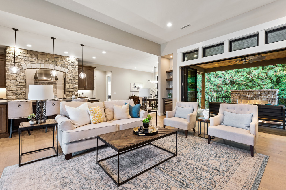 Large traditional formal open plan living room in Portland with beige walls, bamboo flooring, a standard fireplace, a stone fireplace surround, a built-in media unit and multi-coloured floors.