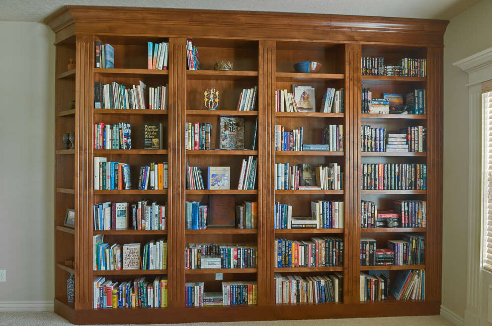 Example of a large classic enclosed carpeted living room library design in Boise with beige walls