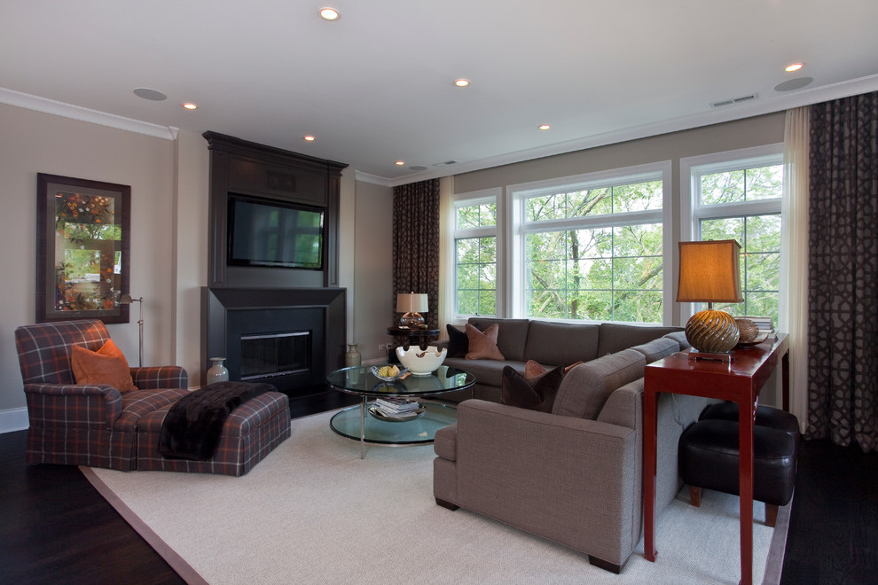 Example of a classic living room design in Chicago with beige walls and a wall-mounted tv