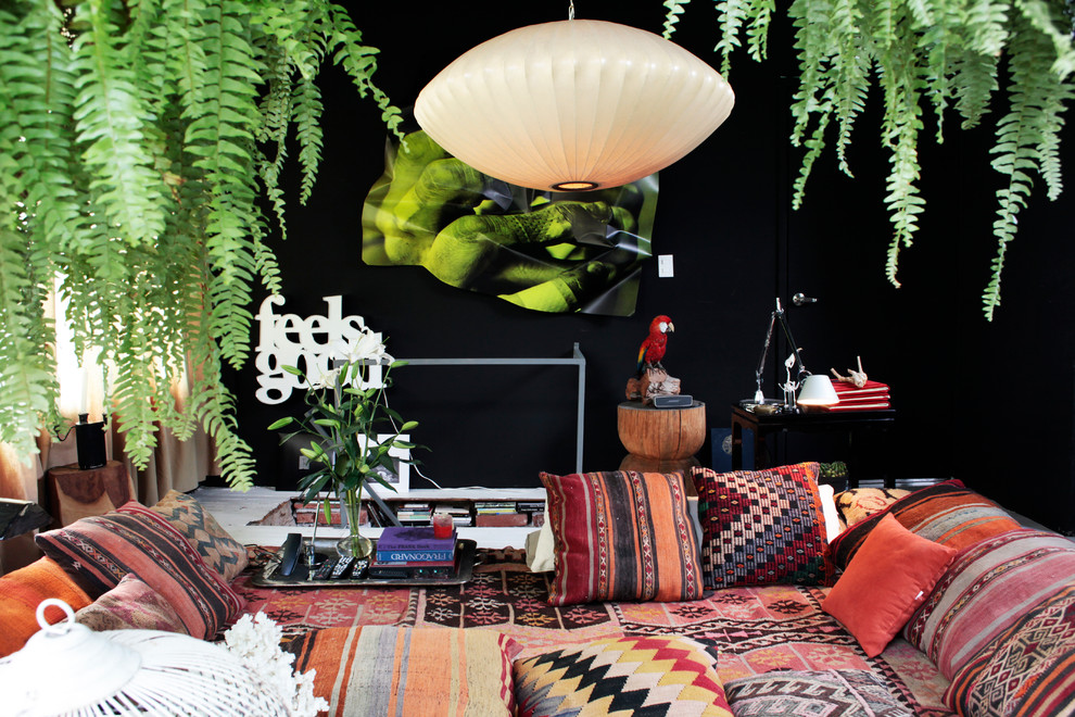 Photo of a world-inspired mezzanine living room in Mexico City with a music area, black walls, carpet and no tv.