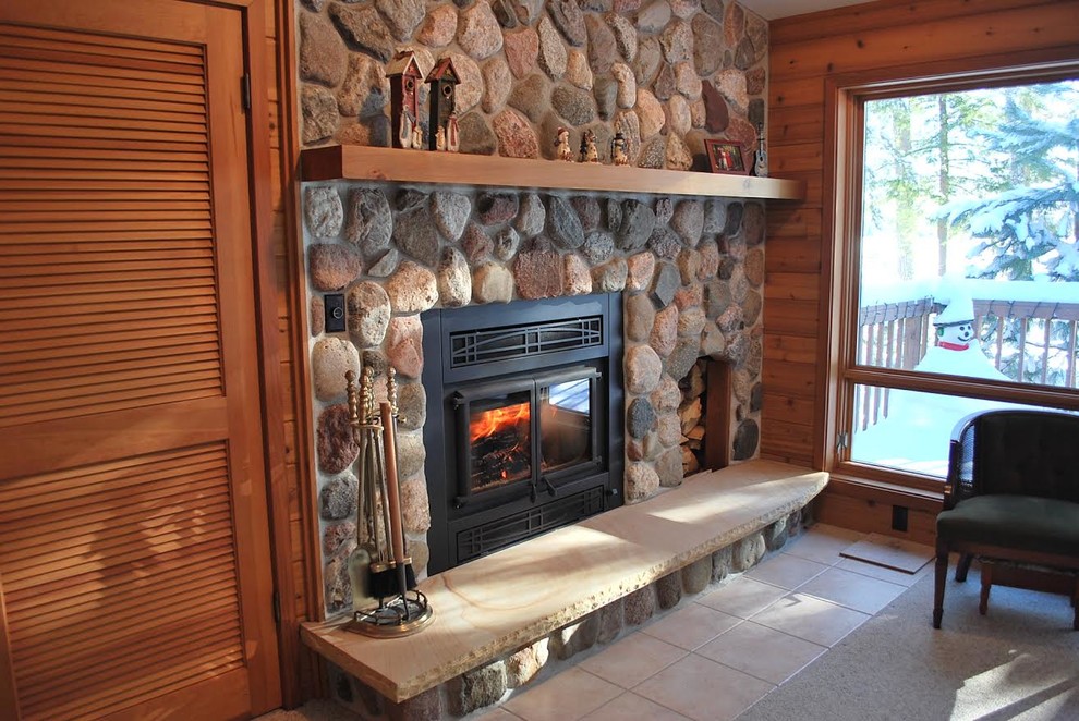 This is an example of a medium sized rustic formal enclosed living room in Other with multi-coloured walls, ceramic flooring, a standard fireplace, a stone fireplace surround and no tv.