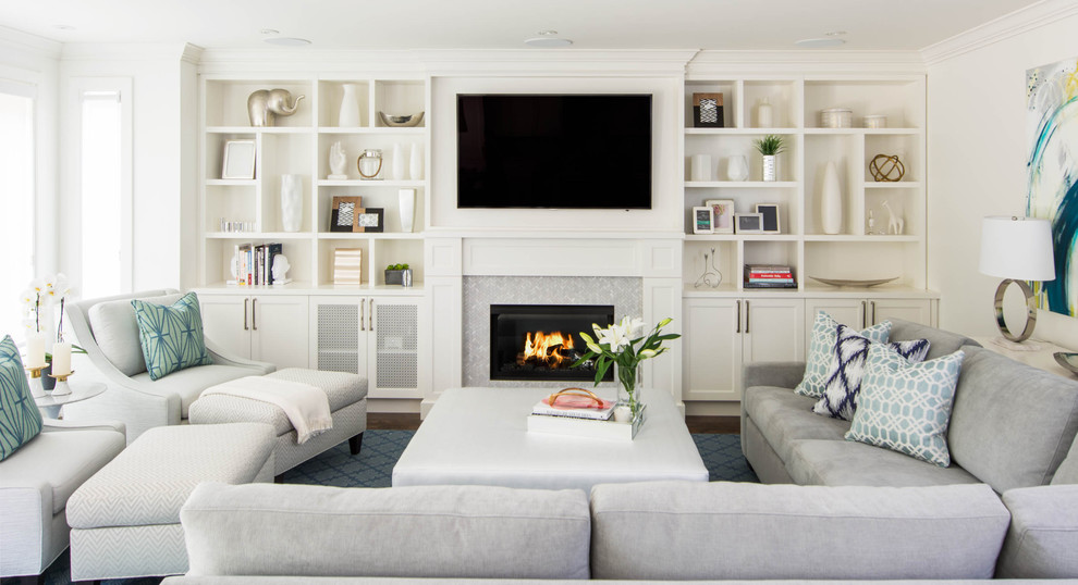 Inspiration for a traditional formal living room in Toronto with white walls, a standard fireplace, a stone fireplace surround, a wall mounted tv and feature lighting.