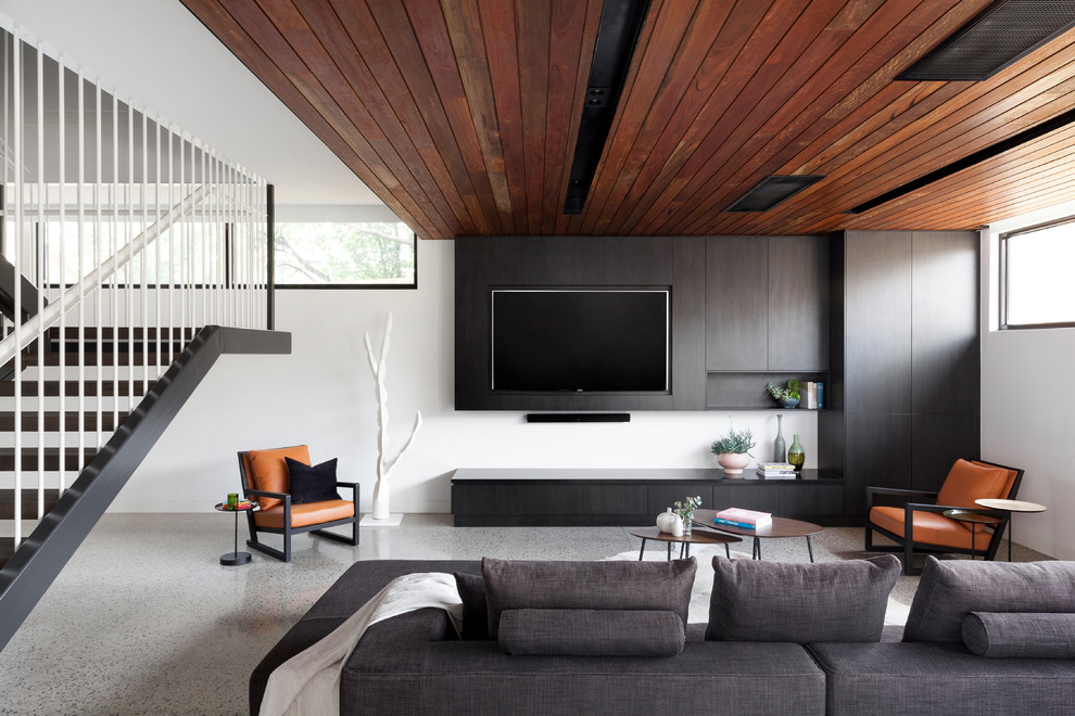 Living room - small modern open concept gray floor and concrete floor living room idea in Melbourne with white walls and a wall-mounted tv